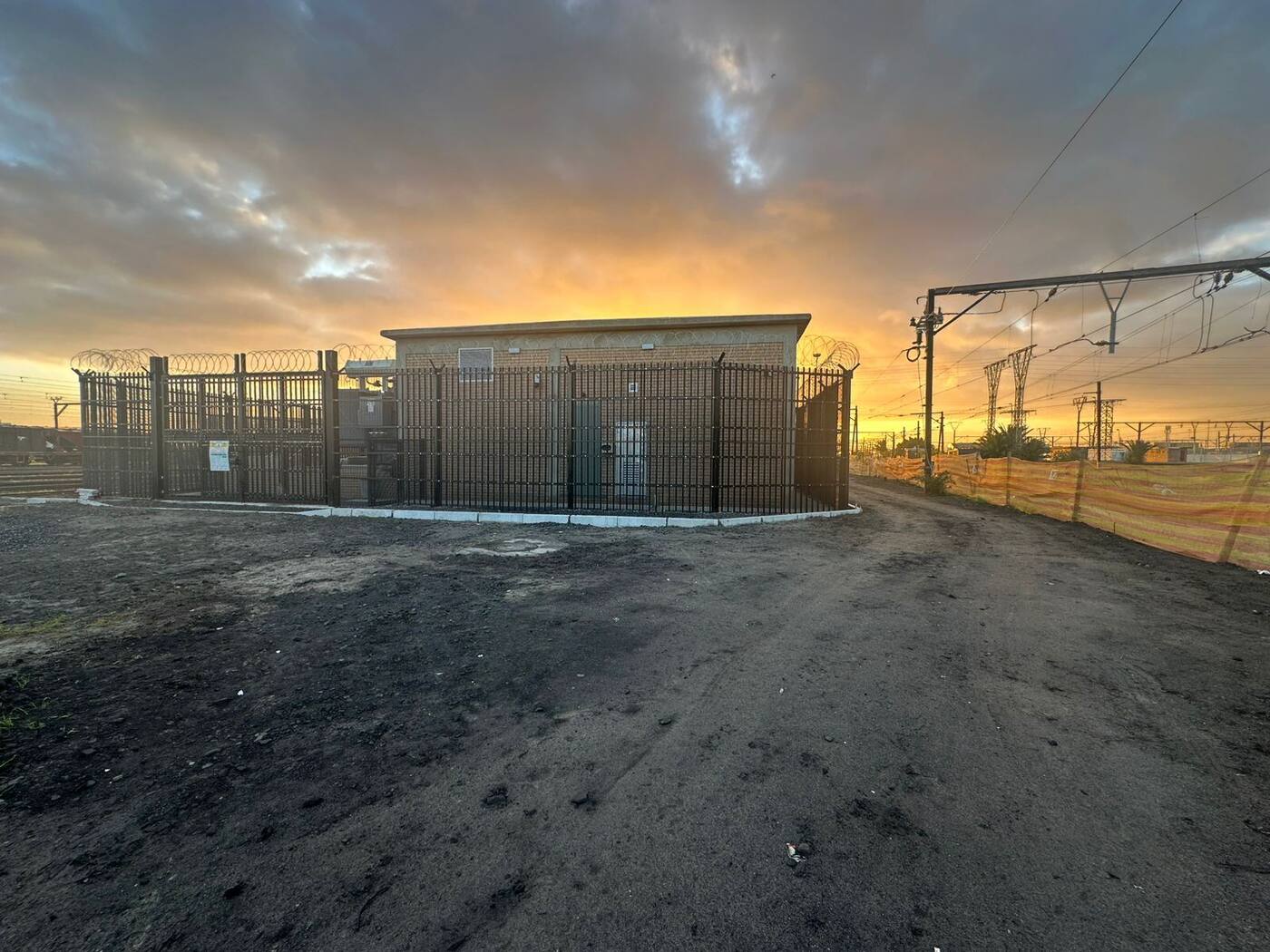 Completed Paarden Eiland traction substation at sunset with security fencing