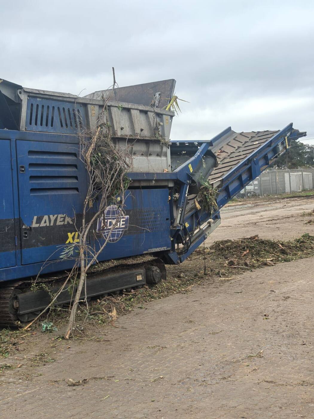 Mobile wood chipper processing garden waste