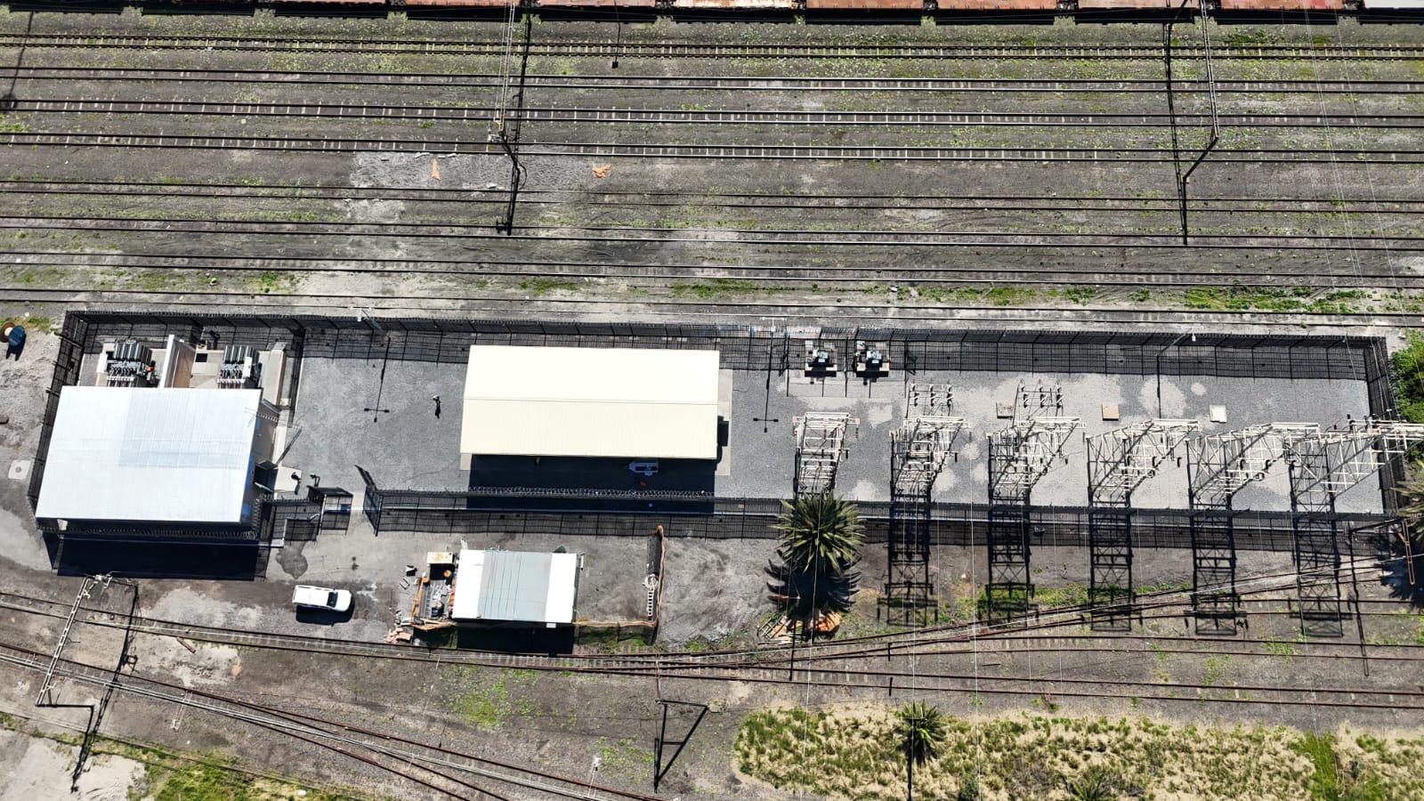 Top-down aerial view of completed Paarden Eiland substation alongside rail yard with switchgear and gantries